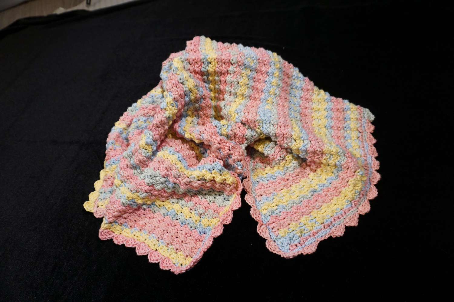 Hand-crocheted cotton pastel baby blanket.