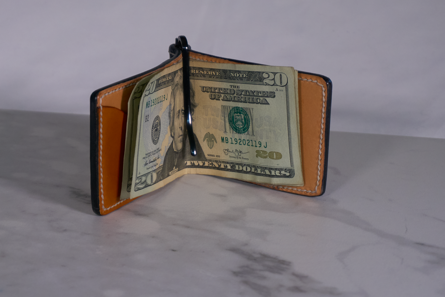 Interior of money clip with natural leather lining and dark brown interior pocket