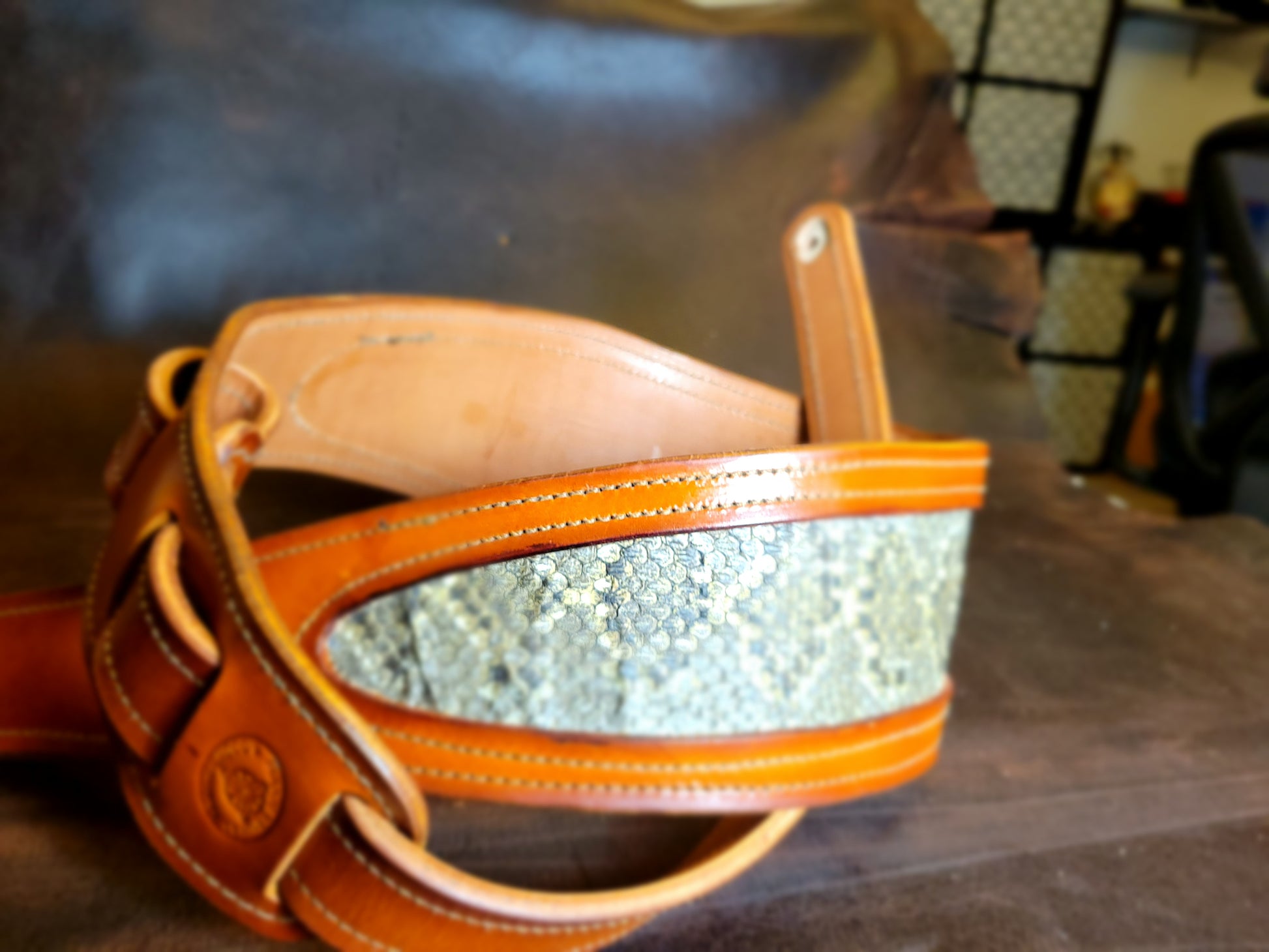 Coiled up top-grain leather guitar strap with Georgia rattlesnake inlay.