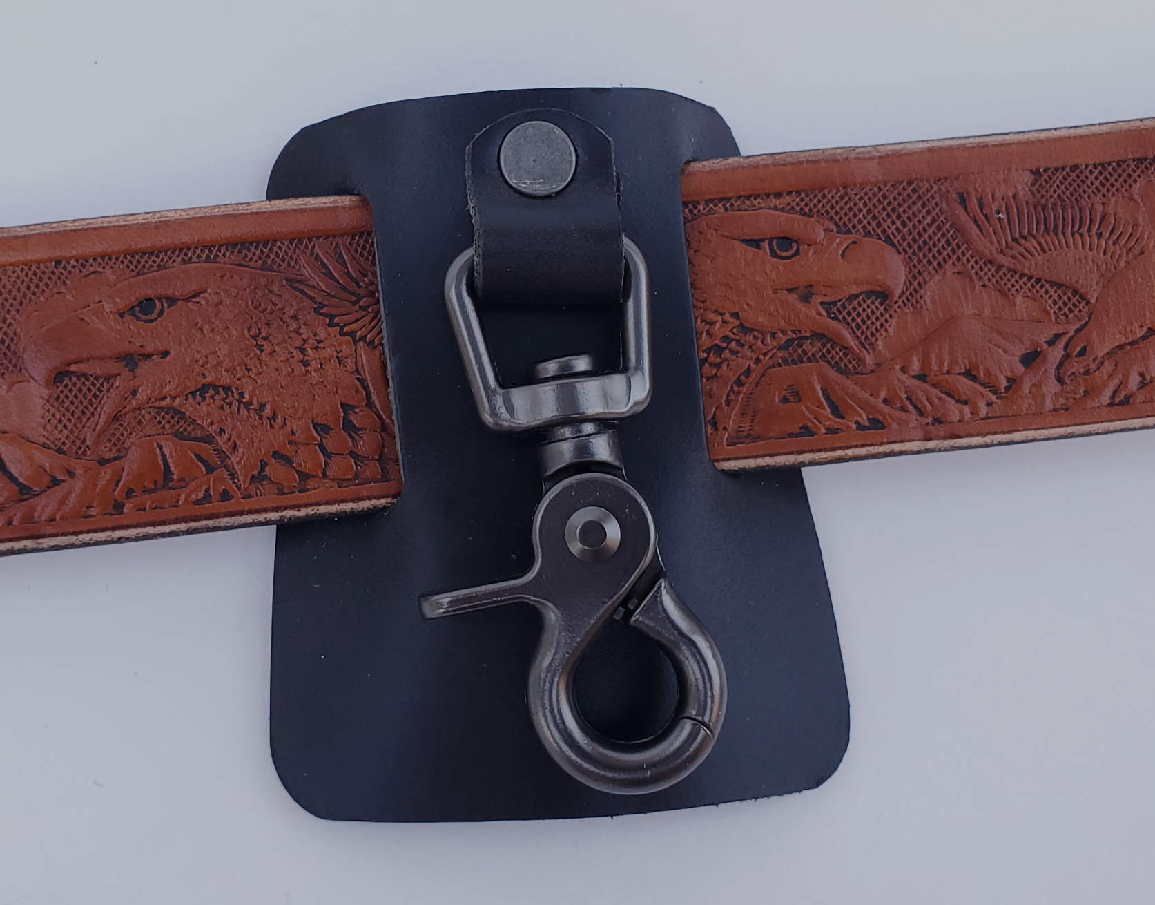 Heavy-duty trigger swivel snap to hold keyrings, mounted on thick black leather with belt slots.