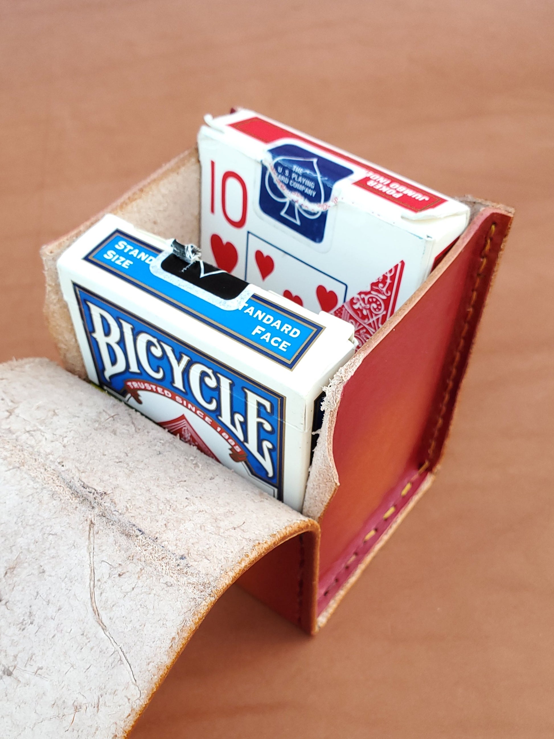 Red leather box with two packs of playing cards.