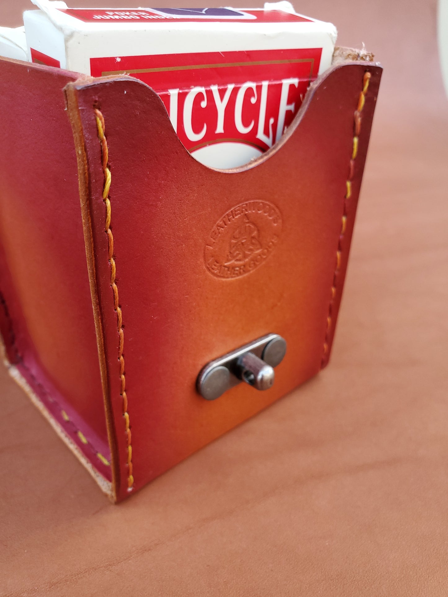 Front of a red leather box with two packs of playing cards.