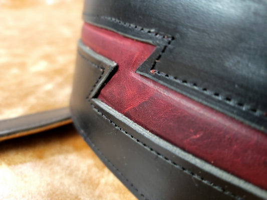 Heavy black leather lined guitar strap with red lightning padded inlay.
