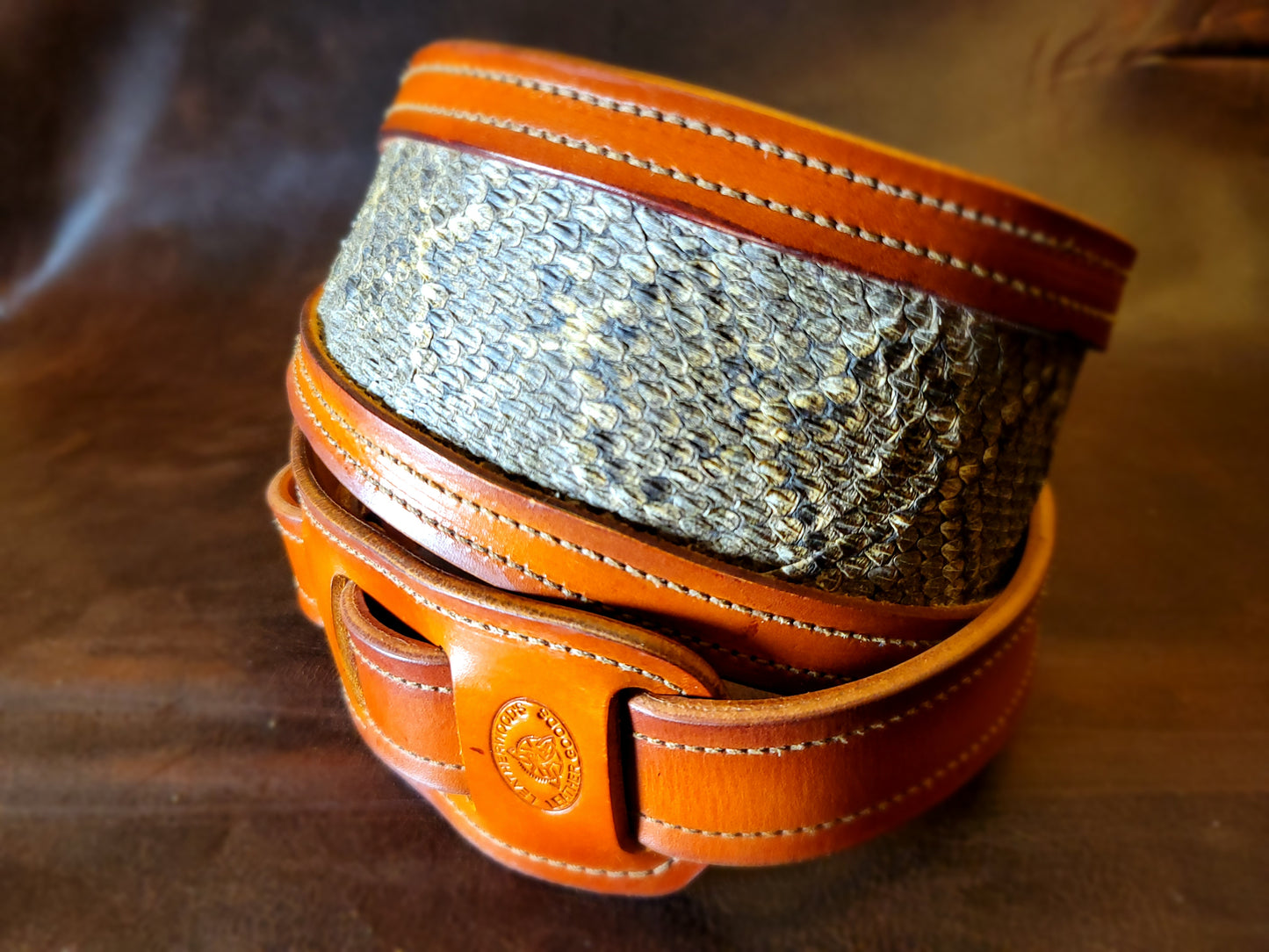 Top-grain leather guitar strap with Georgia rattlesnake inlay highlighting inlay and stitching