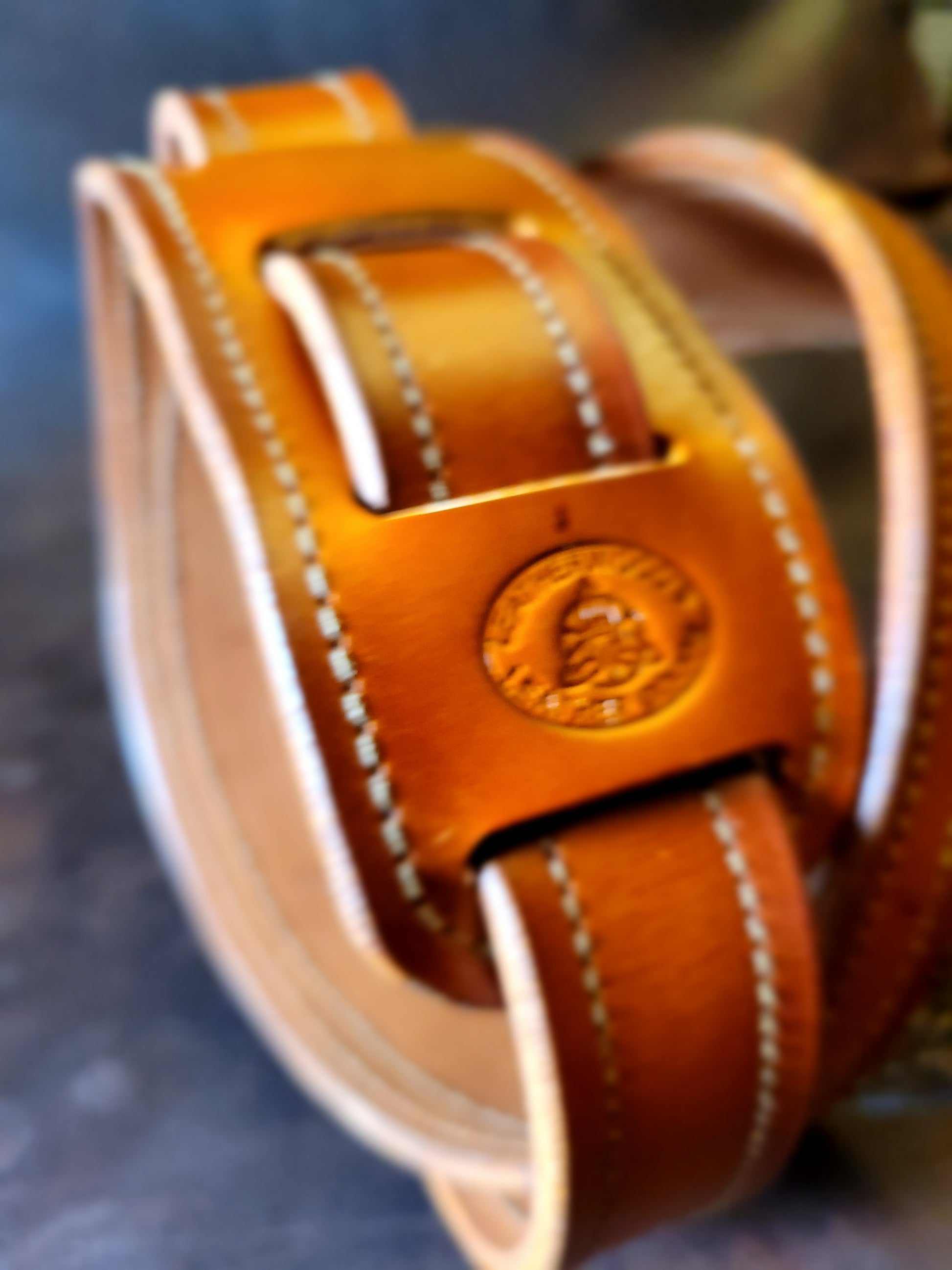 Top-grain leather guitar strap with Georgia rattlesnake inlay highlighting makers mark.