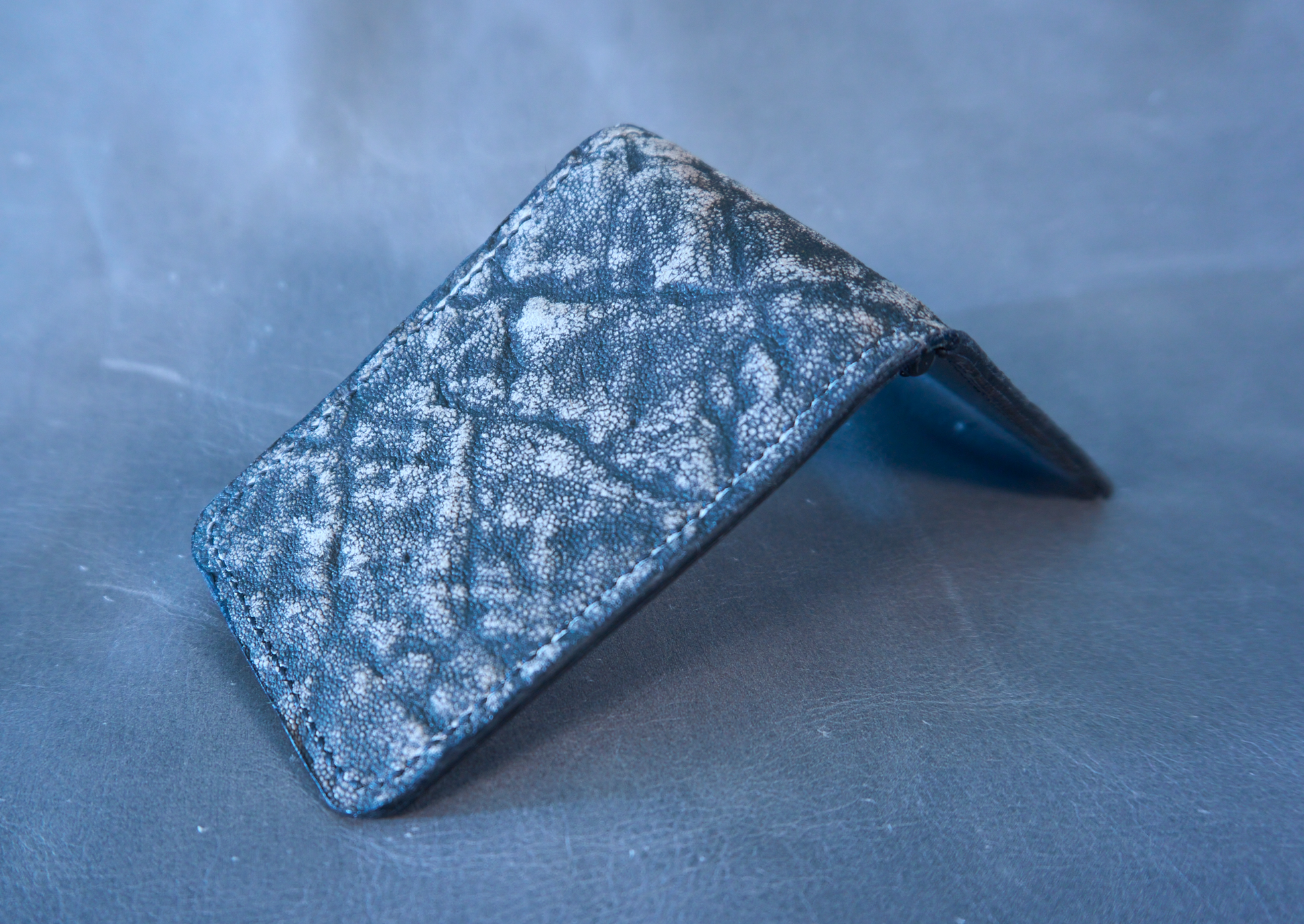 Money clip with grey and brown elephant ear exterior and black interior