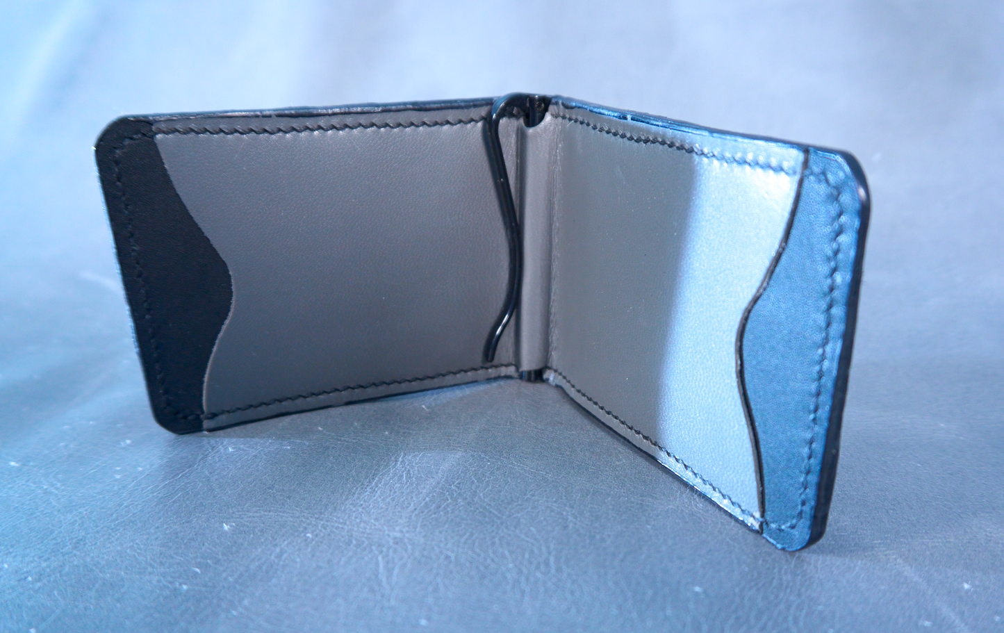 Interior of money clip showing black lining and grey pockets