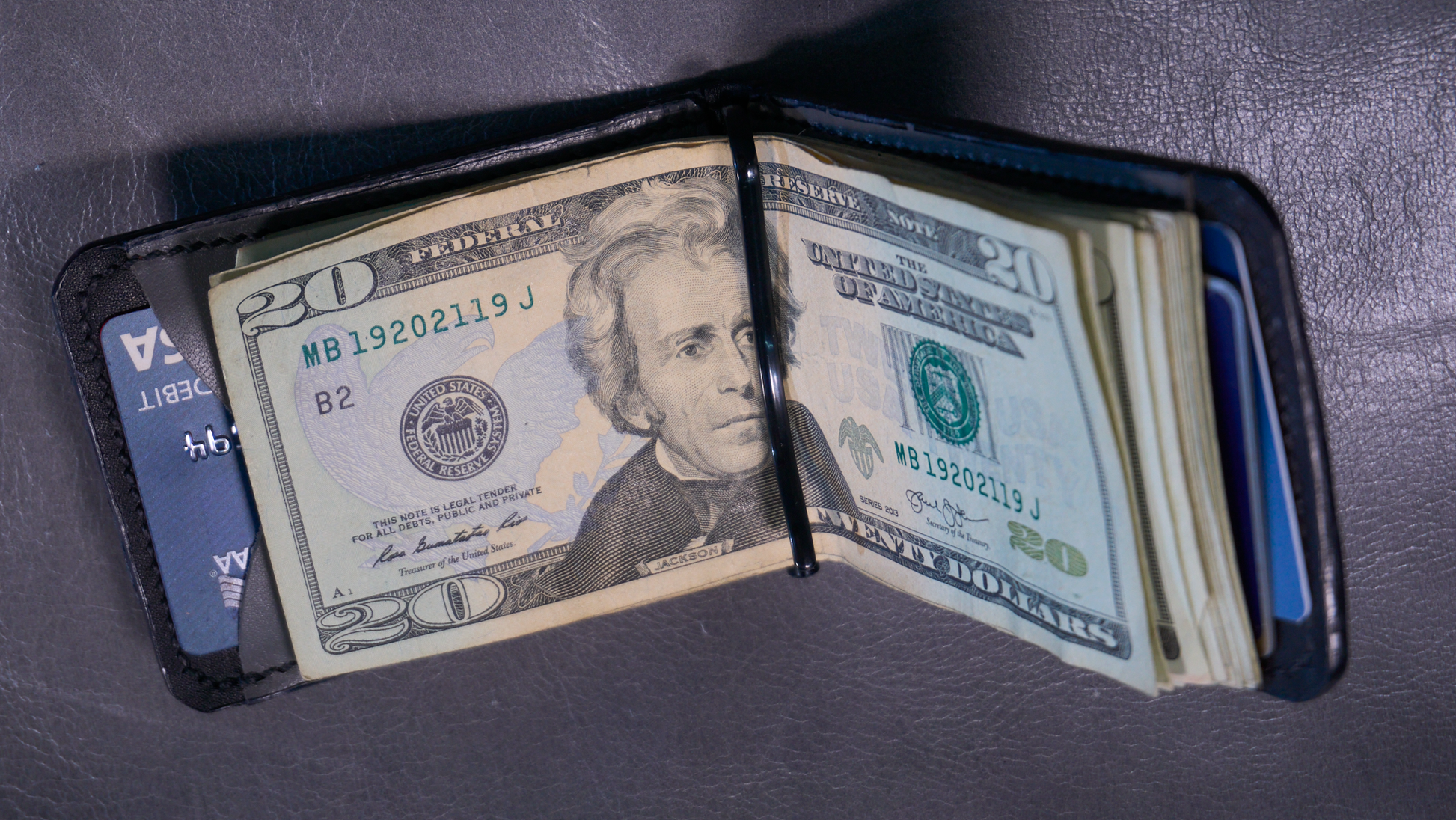 Interior of money clip with black lining and grey card pockets whoing cards and cash