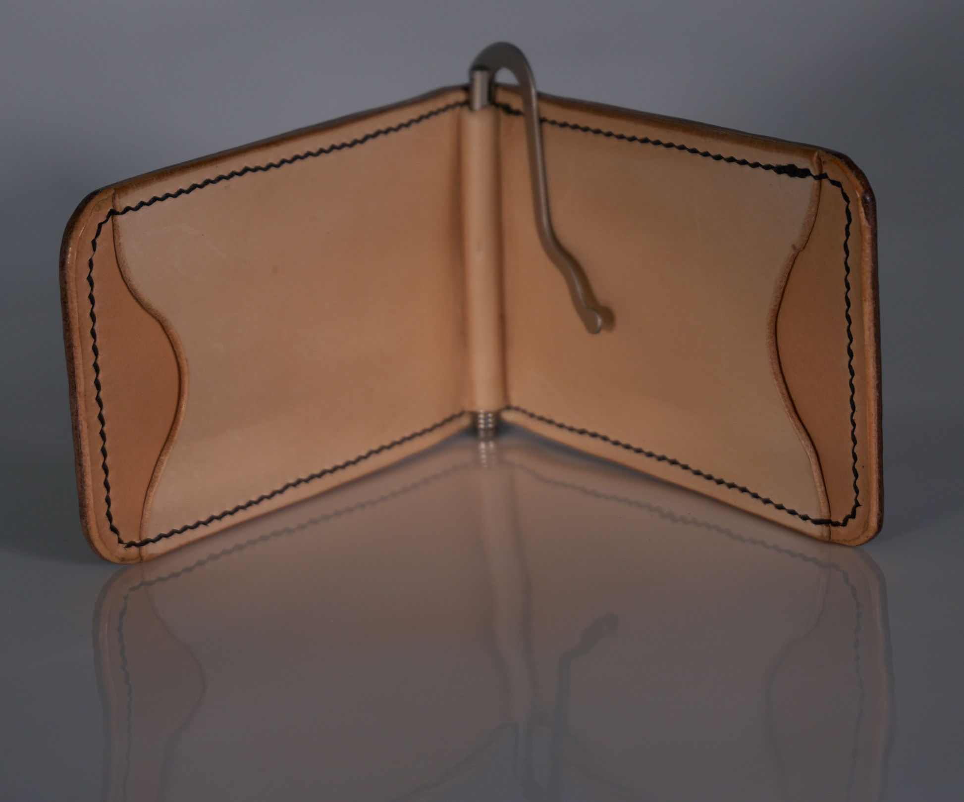 Interior of money clip showing natural leather lining and tan card pockets