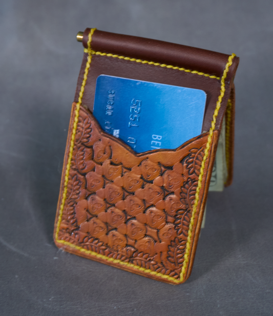 Money clip with classic brown exterior, two tooled exterior card pockets, and contrasting yellow stitching