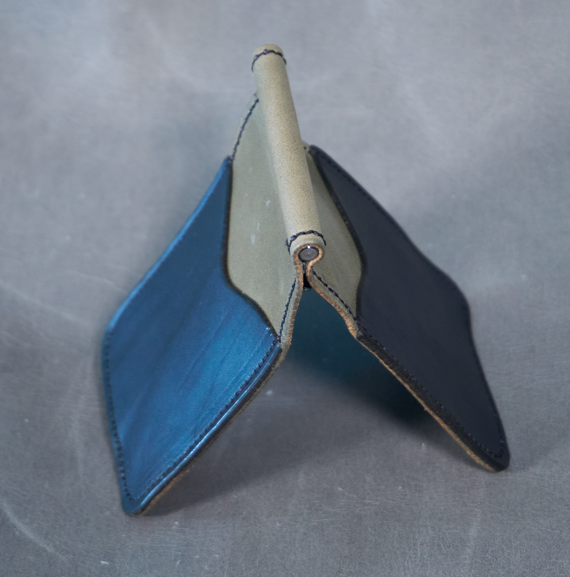 Money clip with soft grey leather exterior and two black exterior card pockets