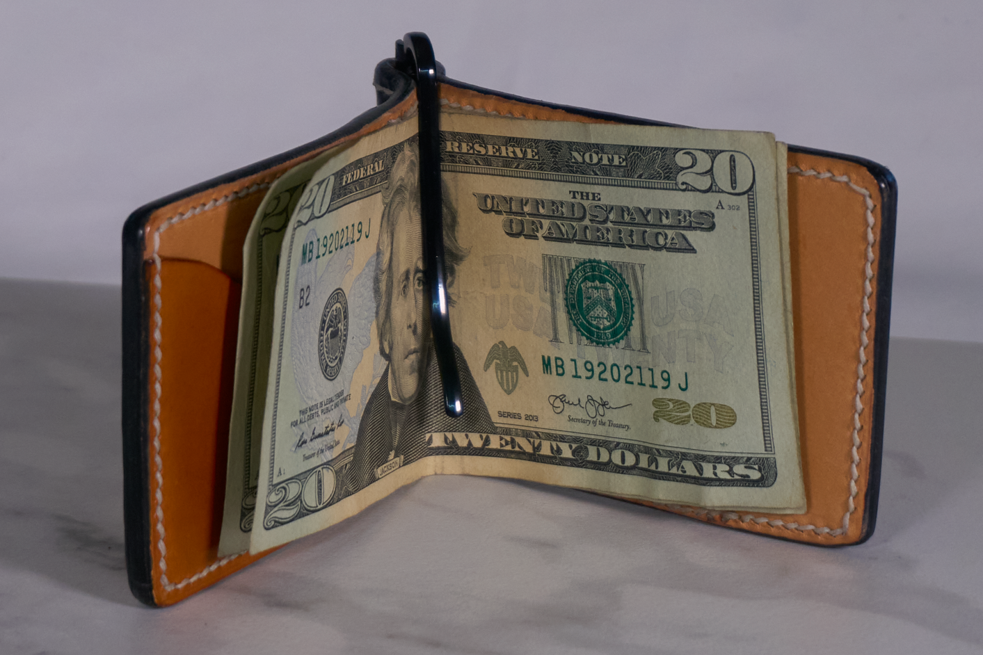 Interior of black leather money clip with harness eather lining